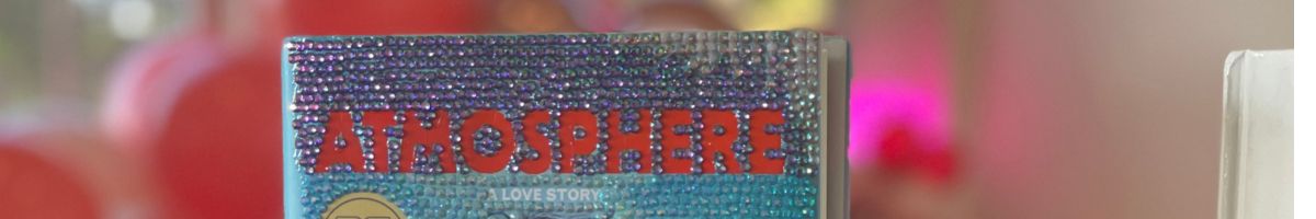 Close-up of a gem-covered book at a Cozy Girls Getaways book bedazzling event, with sparkling rhinestones decorating the top of the cover